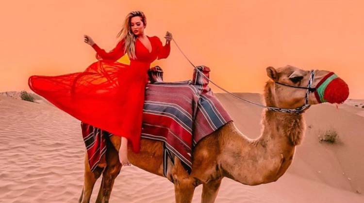 Woman Riding Camel - The Best Overnight Desert Safari Activity