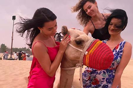 Explore the Majestic Desert Landscape of Dubai - 3 Tourist Girls having Fun with Camel