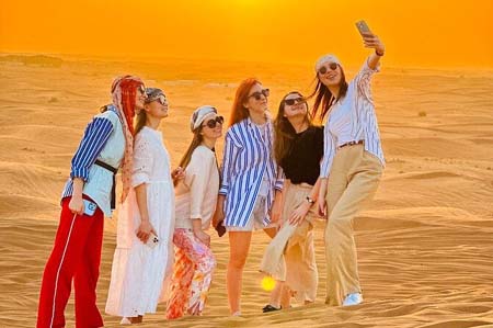 Group of Tourists taking Photos in Arabian Desert Dubai